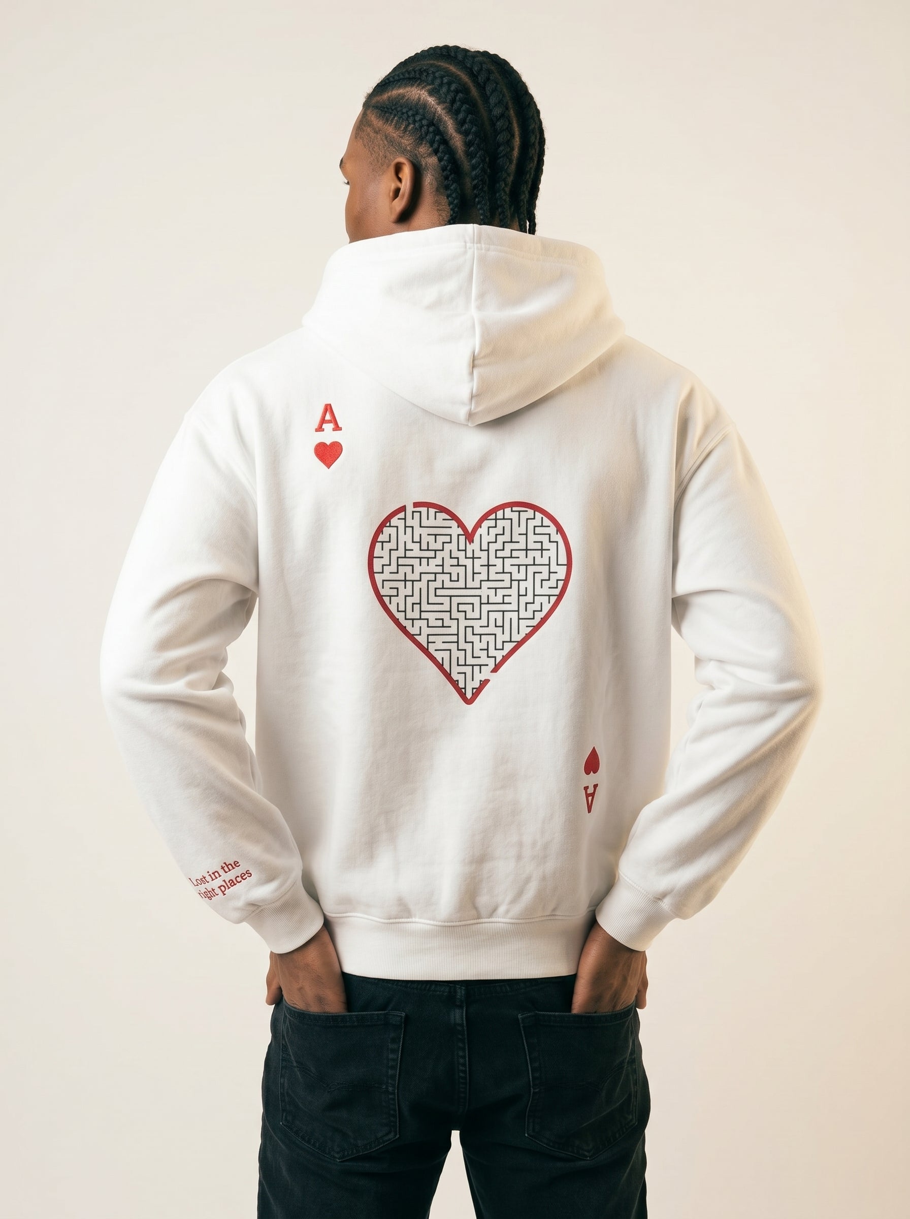Person wearing a white hoodie with a red heart design on the back against a plain background