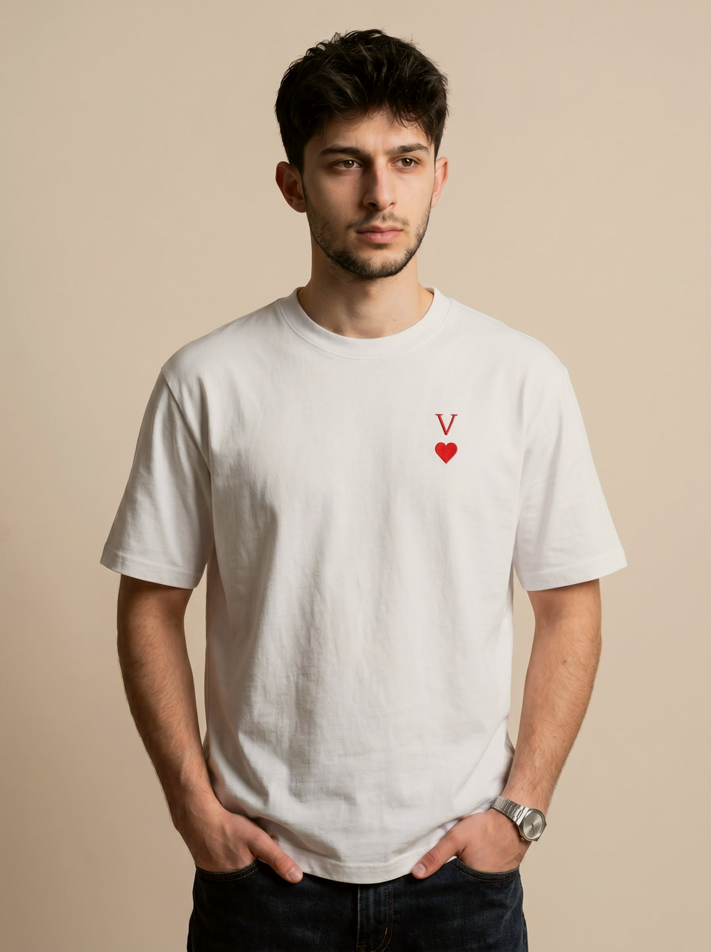 Man wearing a white t-shirt with a red heart and letter 'V' design on a beige background