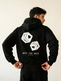 Person wearing a black hoodie with dice design and text on the back