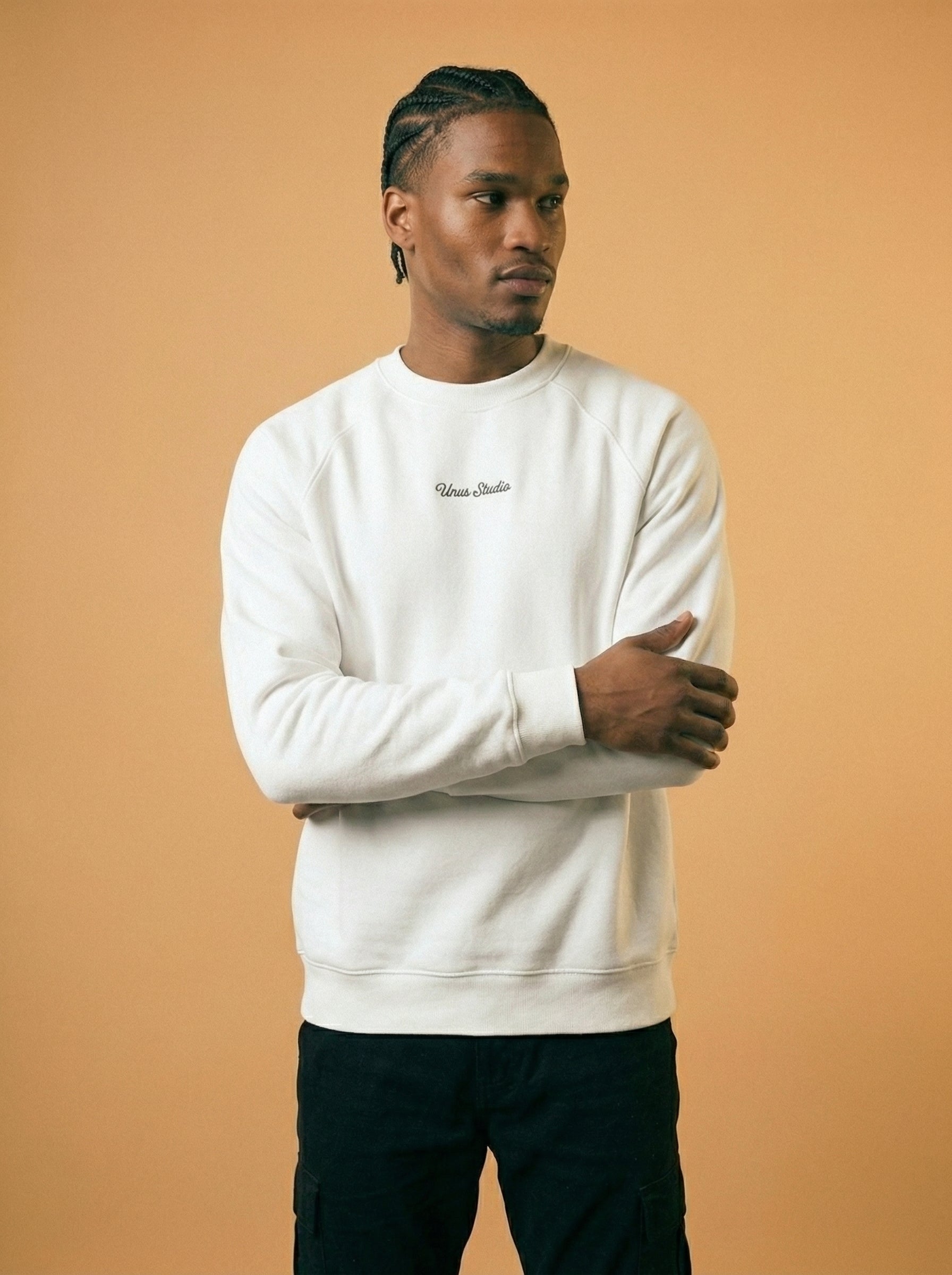 Man wearing a white sweatshirt with text on a beige background