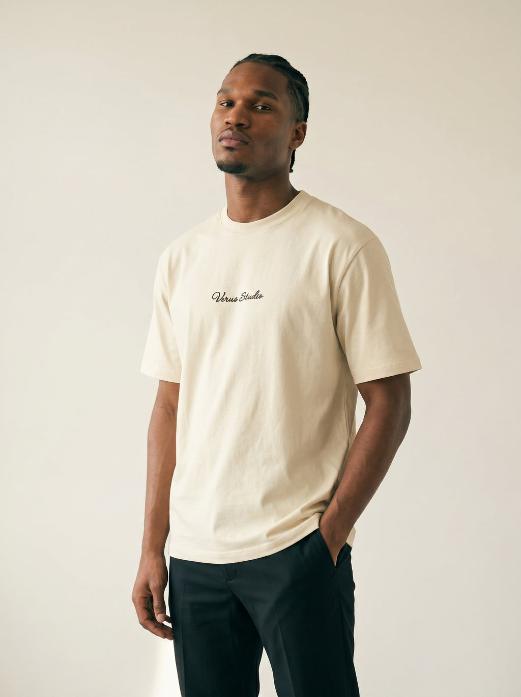 Man wearing a beige t-shirt with text on a plain background